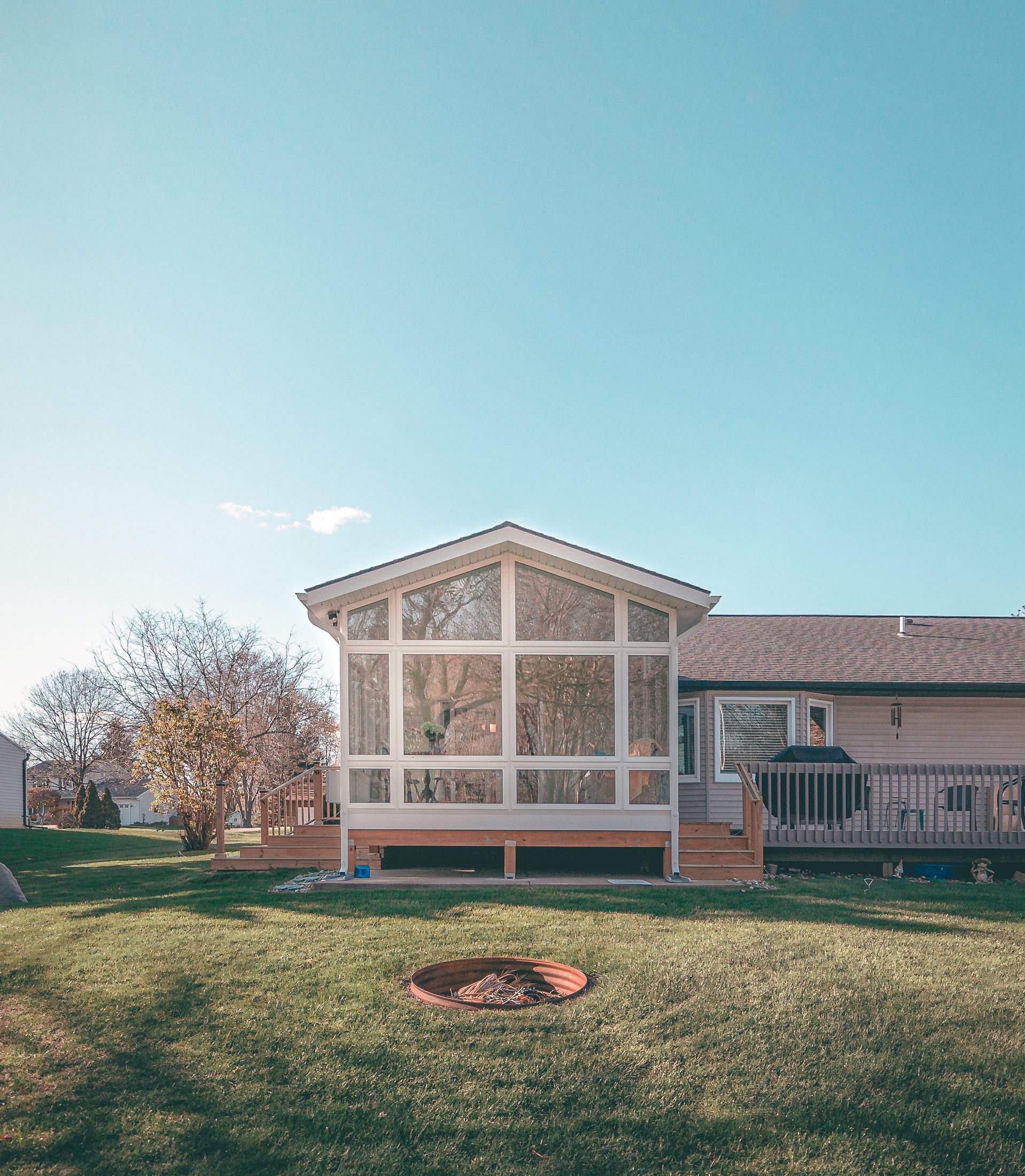Finished four-season LivingSpace sunroom interior at golden hour, South Jersey residential setting