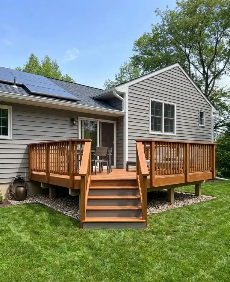 Finished backyard wood deck with railings, steps, and outdoor seating on a South Jersey home built by South Jersey Sunrooms & Decks